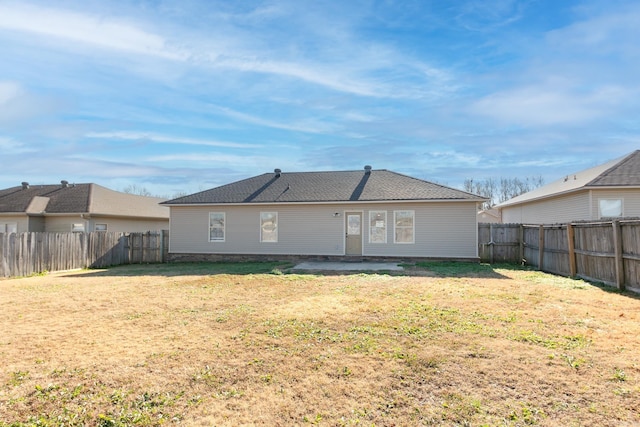 rear view of property with a yard