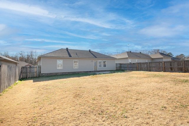 back of house with a lawn