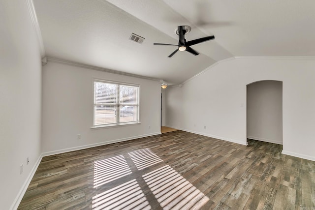 unfurnished room with dark hardwood / wood-style floors, ceiling fan, crown molding, and vaulted ceiling