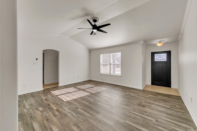 entrance foyer with wood-type flooring, vaulted ceiling, ceiling fan, and crown molding