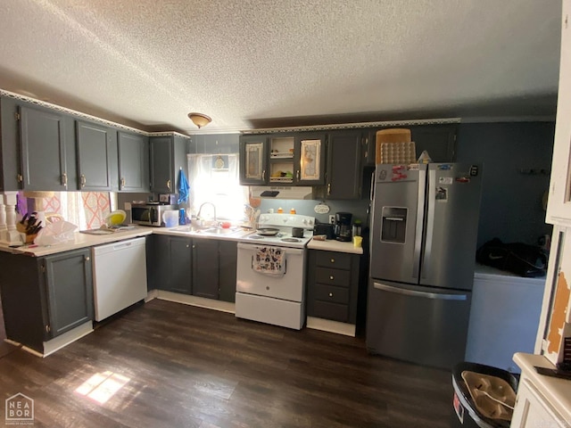 kitchen with appliances with stainless steel finishes, dark hardwood / wood-style floors, gray cabinetry, and sink