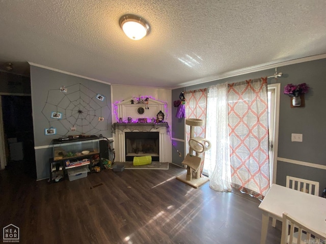 living room with crown molding, hardwood / wood-style floors, and a textured ceiling