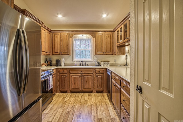 kitchen featuring sink, stainless steel appliances, and light wood-type flooring