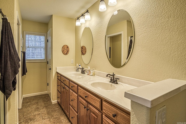 bathroom featuring a textured ceiling and vanity