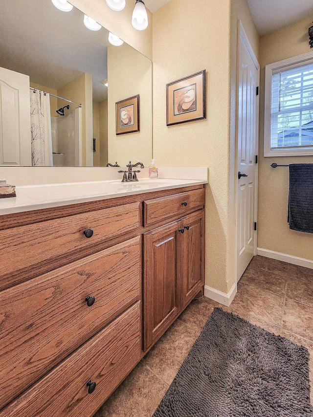 bathroom with tile patterned flooring, vanity, and a shower with shower curtain