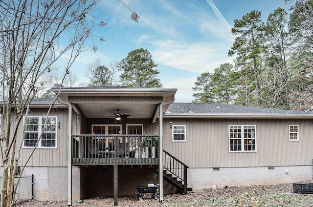 rear view of property featuring ceiling fan and a wooden deck