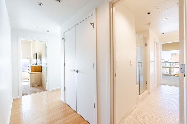 corridor with light wood-type flooring