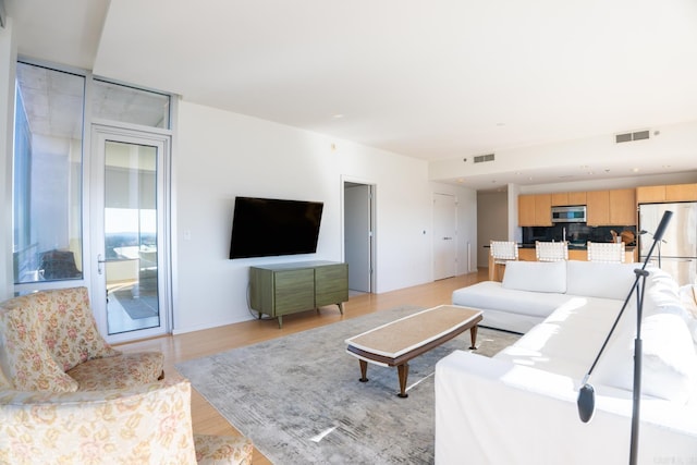 living room with light hardwood / wood-style floors