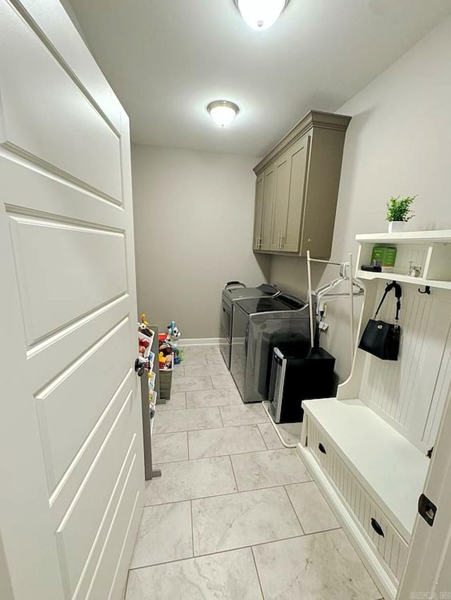 washroom featuring cabinets and independent washer and dryer