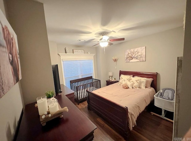 bedroom featuring dark hardwood / wood-style flooring and ceiling fan