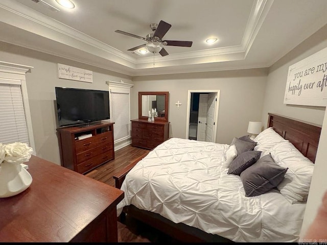 bedroom featuring crown molding, ceiling fan, dark hardwood / wood-style flooring, and a raised ceiling