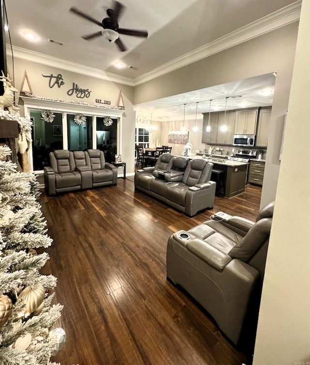 living room with crown molding, ceiling fan, and dark hardwood / wood-style floors