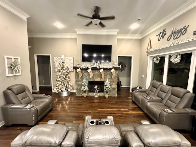 living room with crown molding, dark wood-type flooring, ceiling fan, and a fireplace