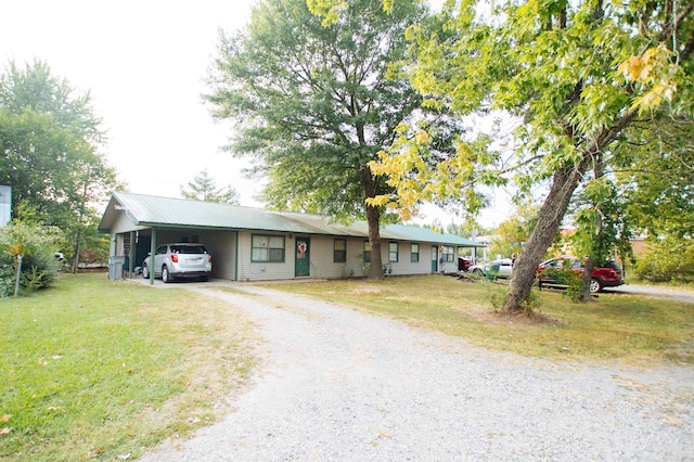 single story home featuring a carport and a front yard