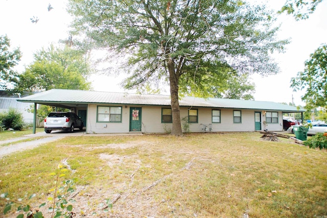 single story home with a front lawn and a carport