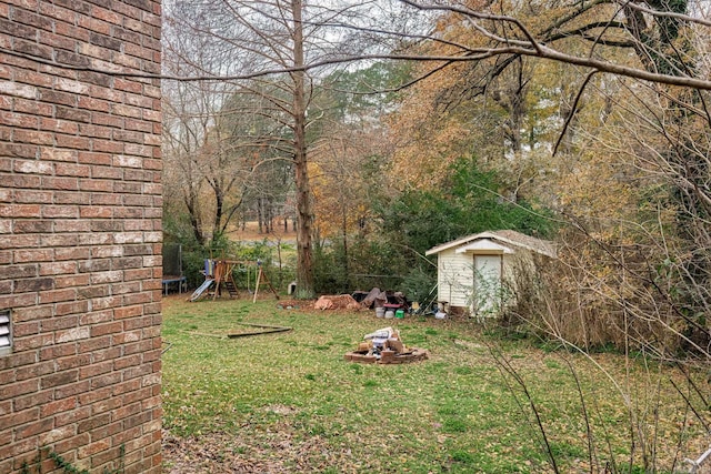 view of yard featuring a storage shed and a playground