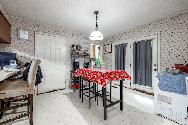 carpeted dining area with crown molding and a textured ceiling