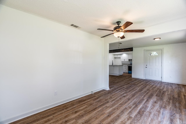 interior space featuring ceiling fan, hardwood / wood-style floors, and a textured ceiling