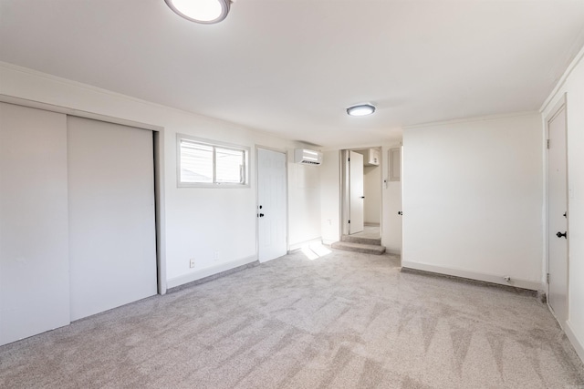 unfurnished bedroom featuring a wall mounted air conditioner, crown molding, light carpet, and a closet