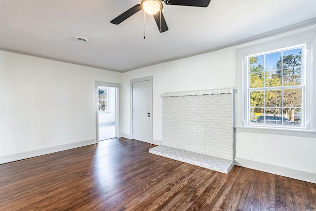 unfurnished room featuring crown molding, ceiling fan, plenty of natural light, and dark wood-type flooring