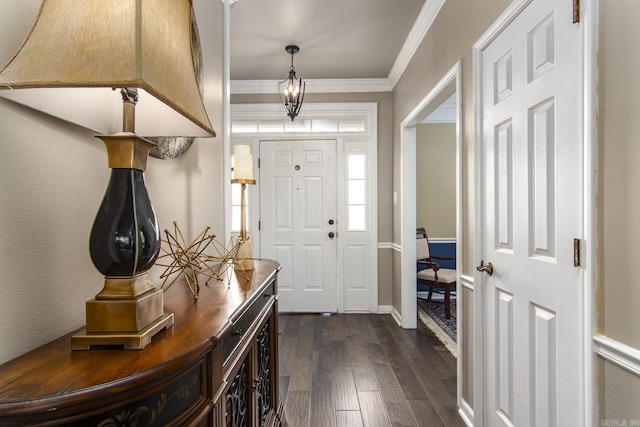 foyer with ornamental molding and dark wood-type flooring