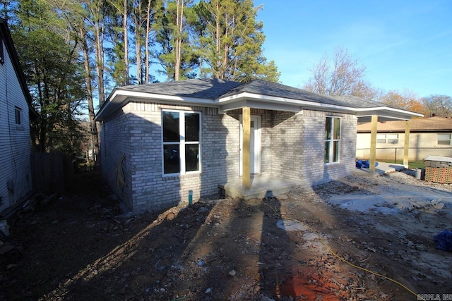 view of front of property featuring fence and brick siding