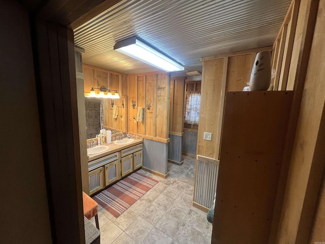 bathroom with vanity and wooden walls