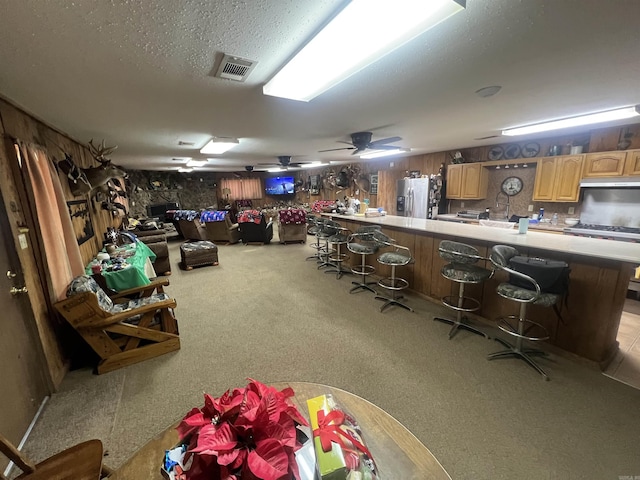 interior space with ceiling fan