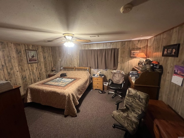 bedroom featuring ceiling fan, carpet, and wood walls