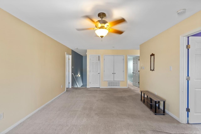 carpeted empty room featuring ceiling fan