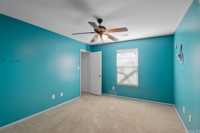 spare room with light carpet and ceiling fan