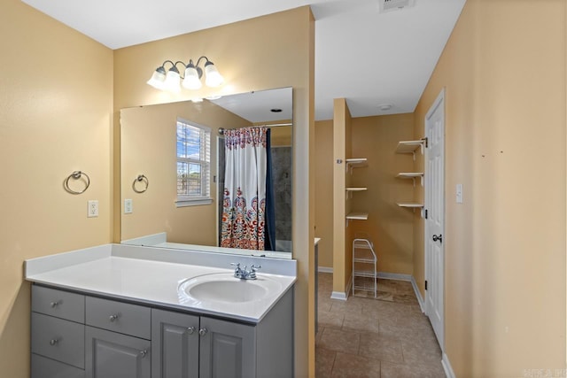 bathroom featuring a shower with shower curtain, vanity, and tile patterned floors