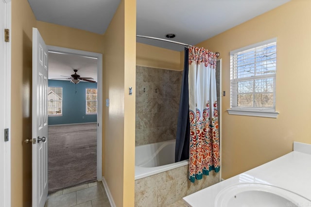 bathroom featuring tile patterned floors, ceiling fan, shower / bath combo with shower curtain, and vanity