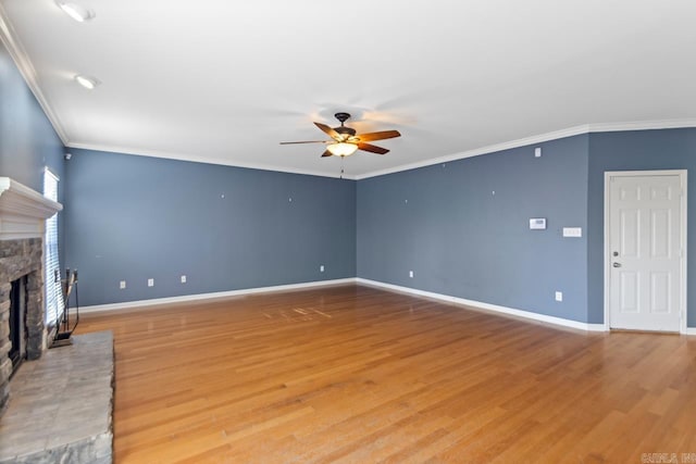 unfurnished living room with a fireplace, wood-type flooring, ceiling fan, and ornamental molding