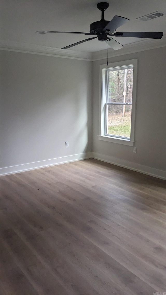 unfurnished room with hardwood / wood-style flooring, ceiling fan, and crown molding