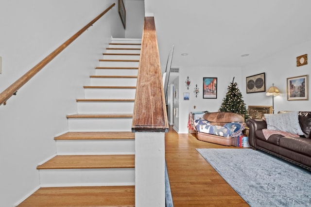 stairway featuring hardwood / wood-style flooring