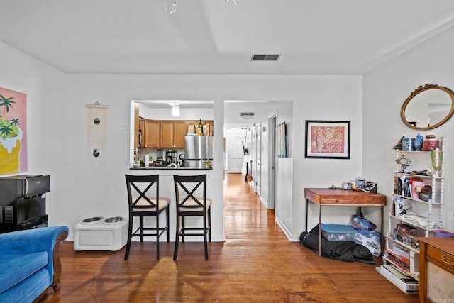 kitchen with stainless steel refrigerator and wood-type flooring