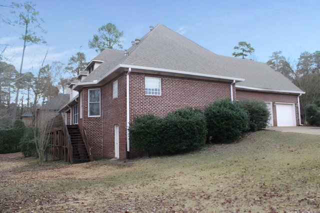 view of side of property with a garage and a yard