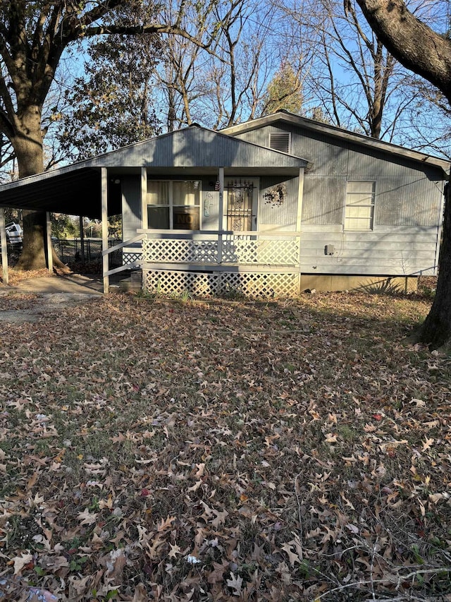 view of front of house featuring a porch and a carport