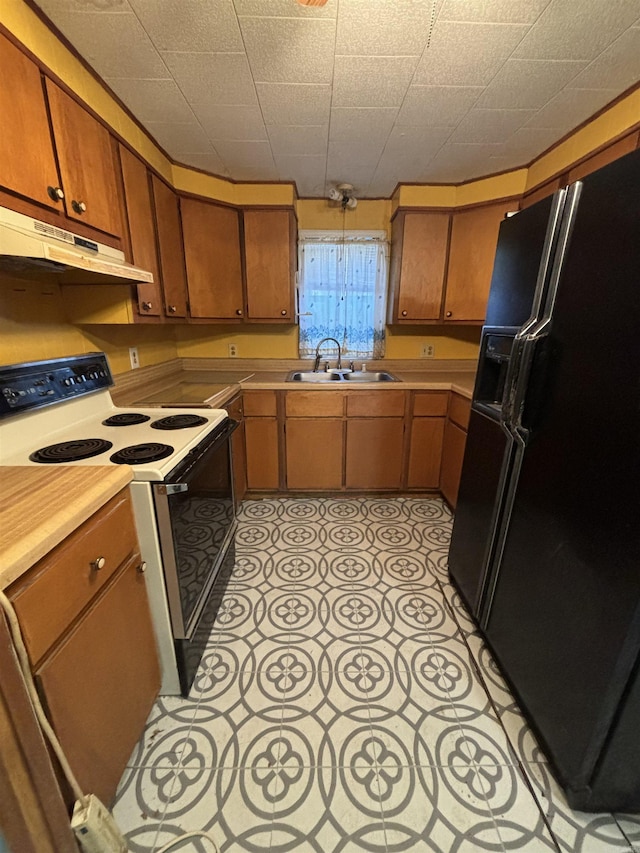 kitchen with white electric range, black refrigerator with ice dispenser, and sink