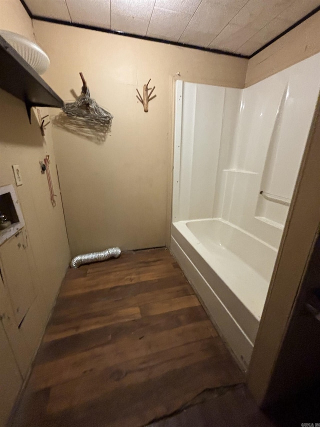 bathroom featuring bathing tub / shower combination and hardwood / wood-style floors