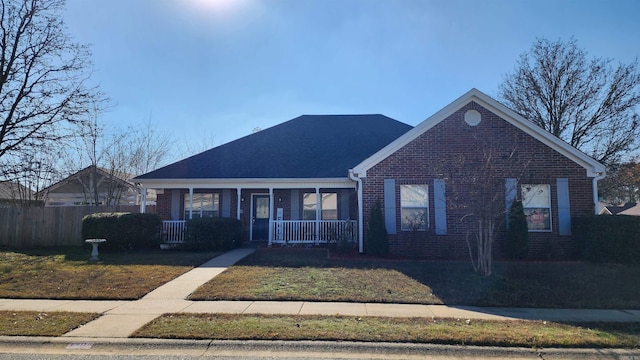 view of front of house featuring covered porch and a front lawn