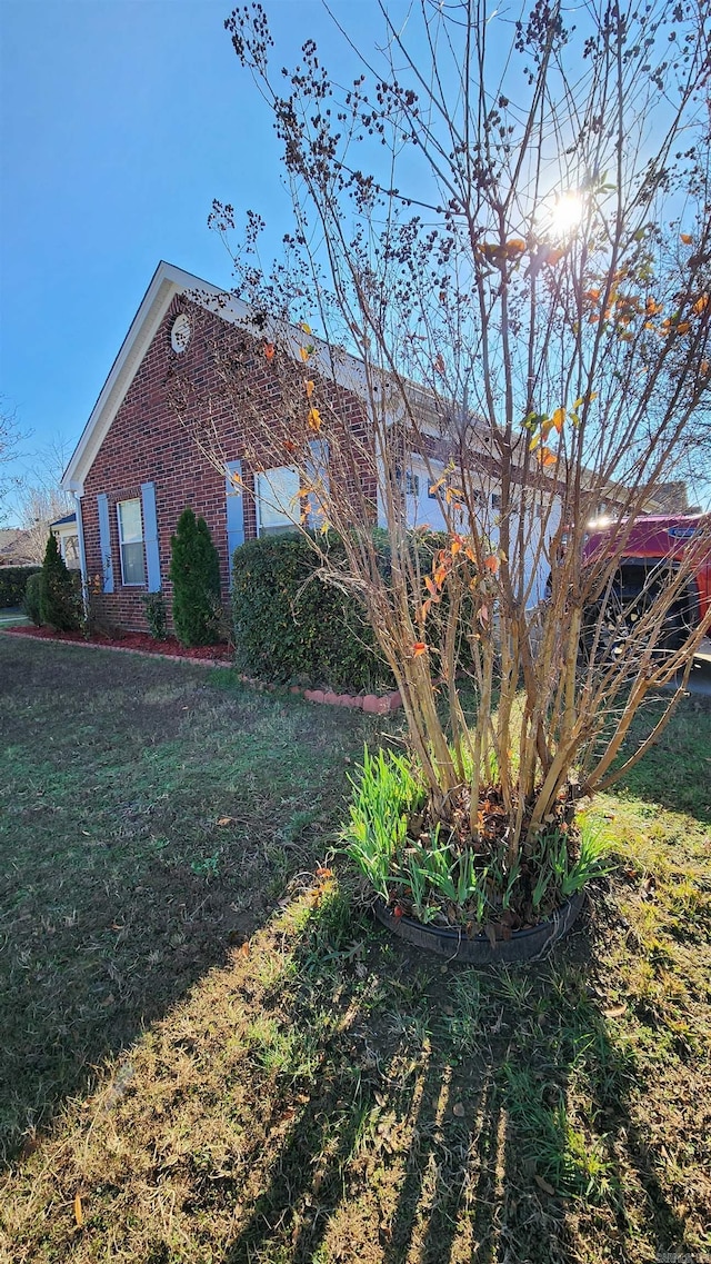 view of side of property with a lawn