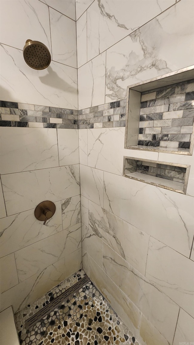 bathroom with a tile shower