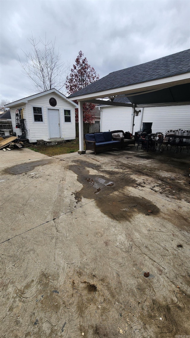 view of property exterior with an outdoor structure and a carport