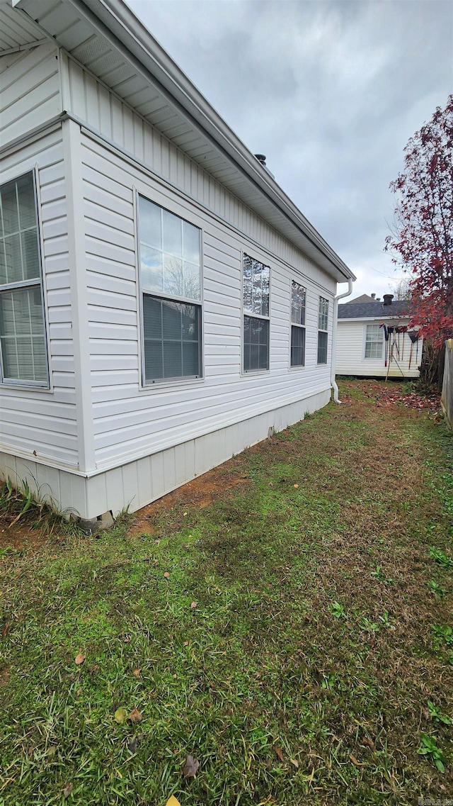 view of home's exterior with a lawn