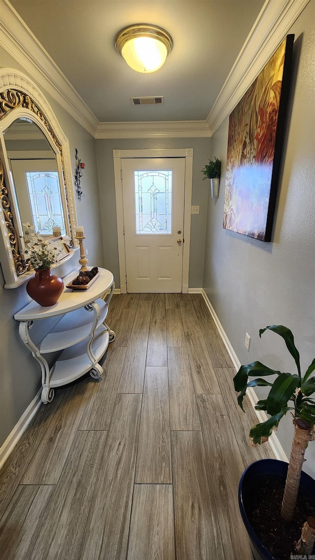 doorway with crown molding and hardwood / wood-style flooring