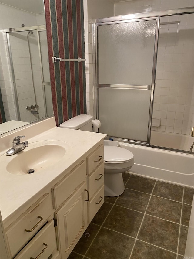 full bathroom with tile patterned flooring, vanity, toilet, and combined bath / shower with glass door