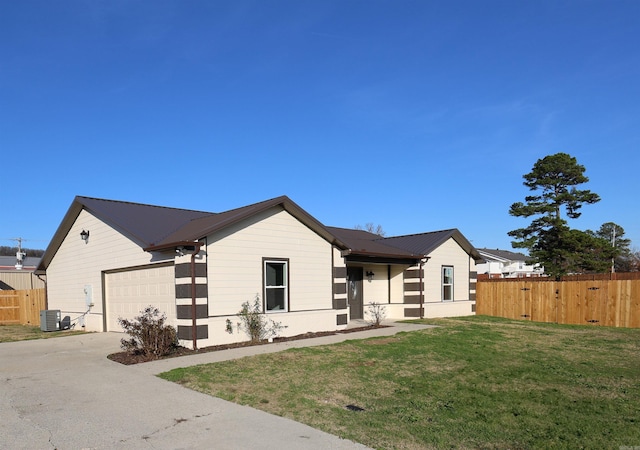 single story home featuring central AC unit, a garage, and a front yard