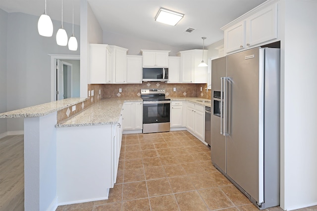 kitchen featuring pendant lighting, white cabinets, tasteful backsplash, kitchen peninsula, and stainless steel appliances